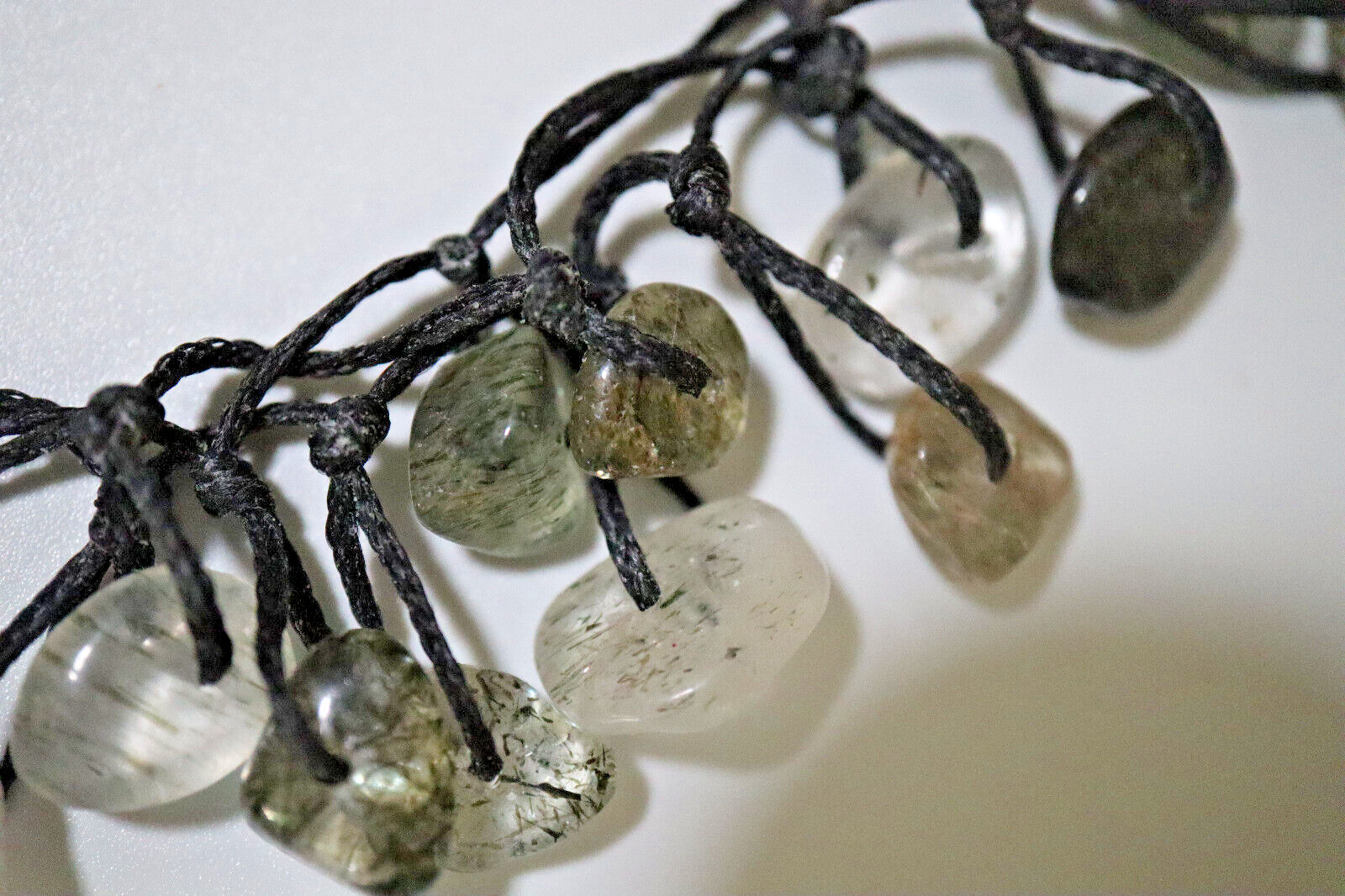 NECKLACE BLACK BRAIDED CORD W/OVER 40 POLISHED RUTILATED QUARTZ STONES 14″-26″