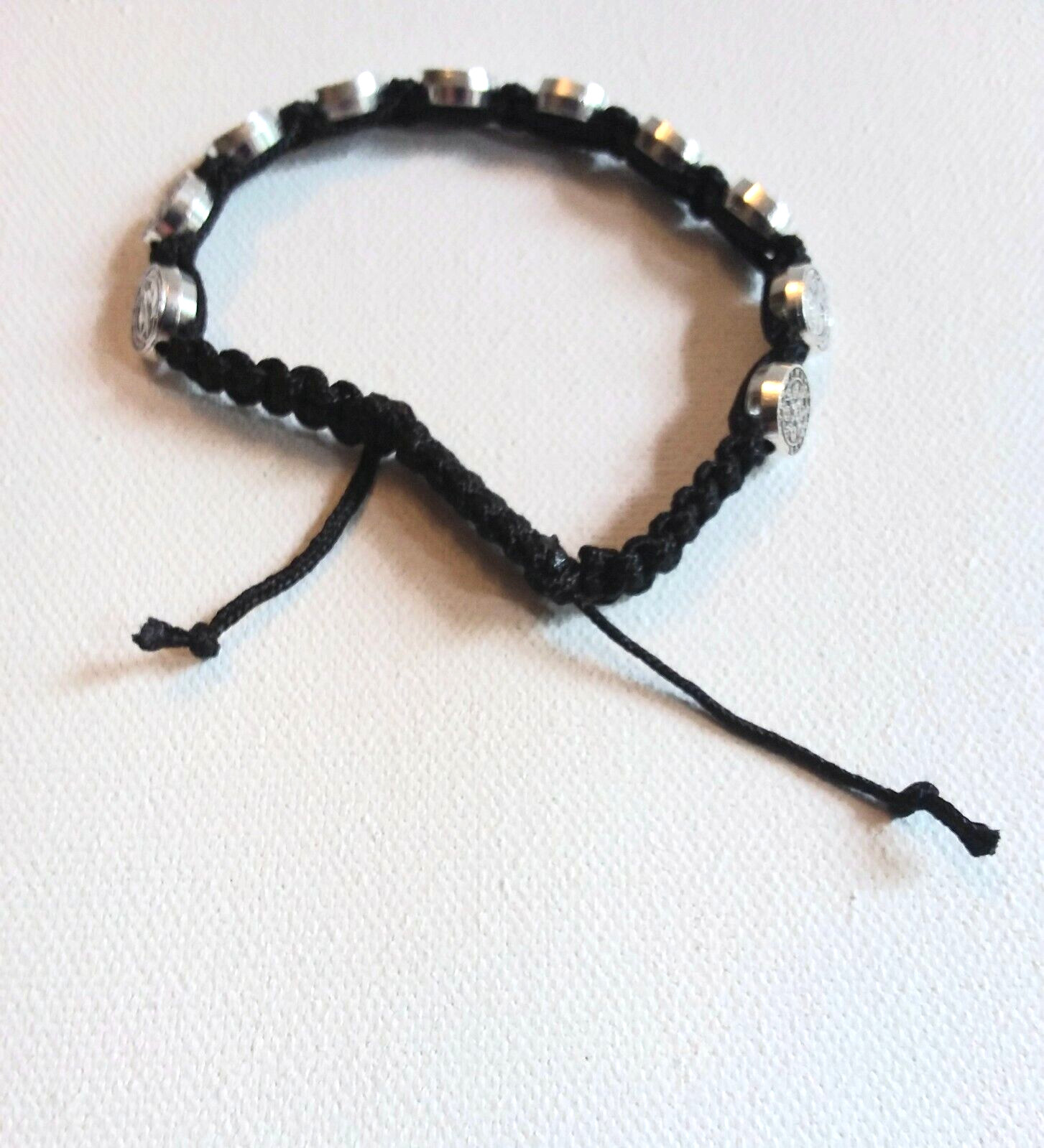 St. Benedict Adjustable Cord Bracelet with 10 Metal Disks. Wrists 6.5″ – 8″