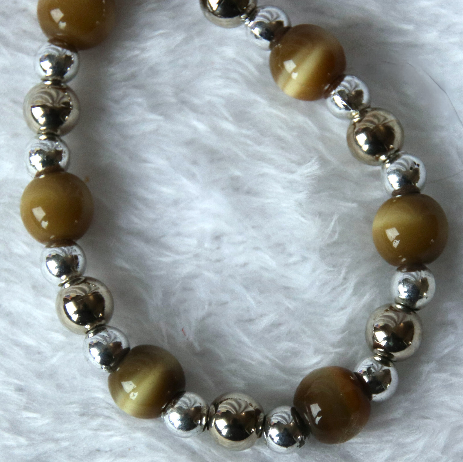 Bracelet of Brown Cat’s Eye Glass with silver colored beads, toggle closure