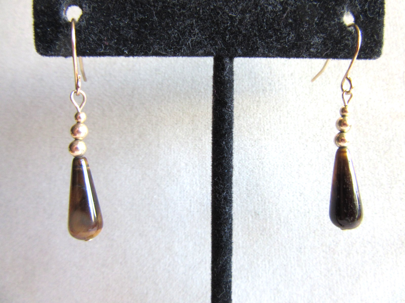 Gold tone hook pierced earrings with teardrop Tigers eye beads