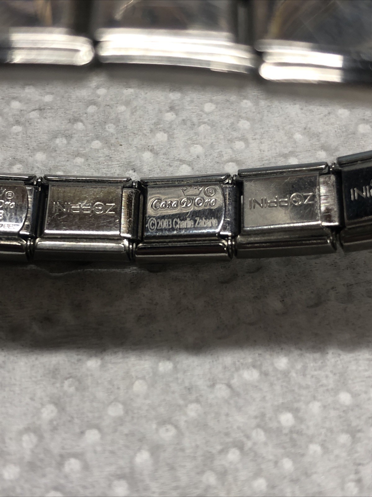 2003- CASA D’ORO ITALIAN STAINLESS STEEL 17 CHARM LINKS STRETCH BRACELET