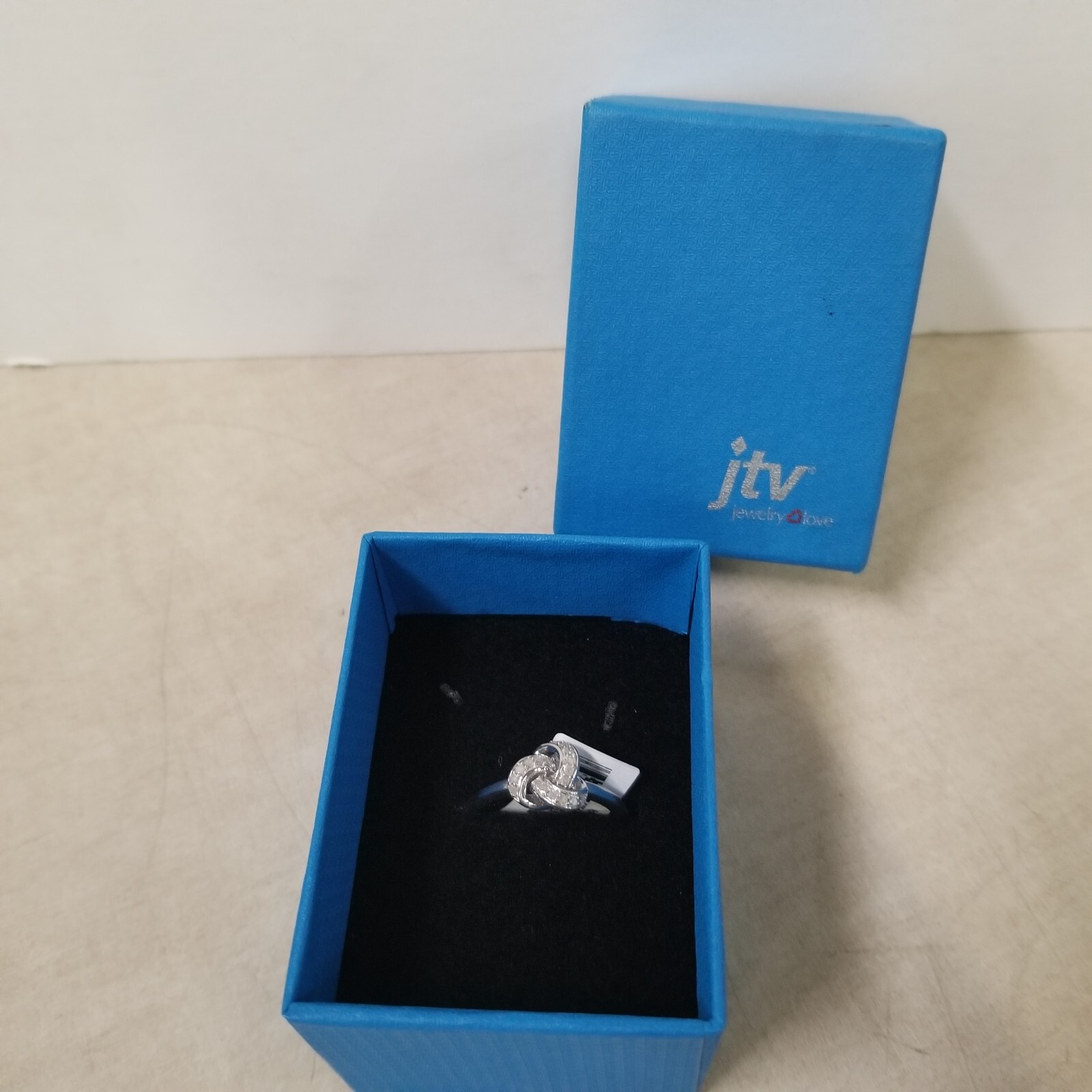 White Diamond Rhodium Over Sterling Silver Knot Ring 0.15ctw