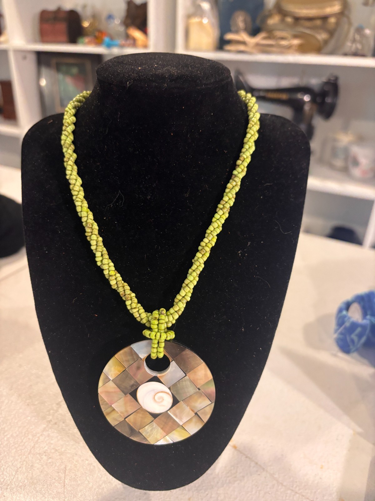 Abalone and shiva shell pendant on green beaded necklace