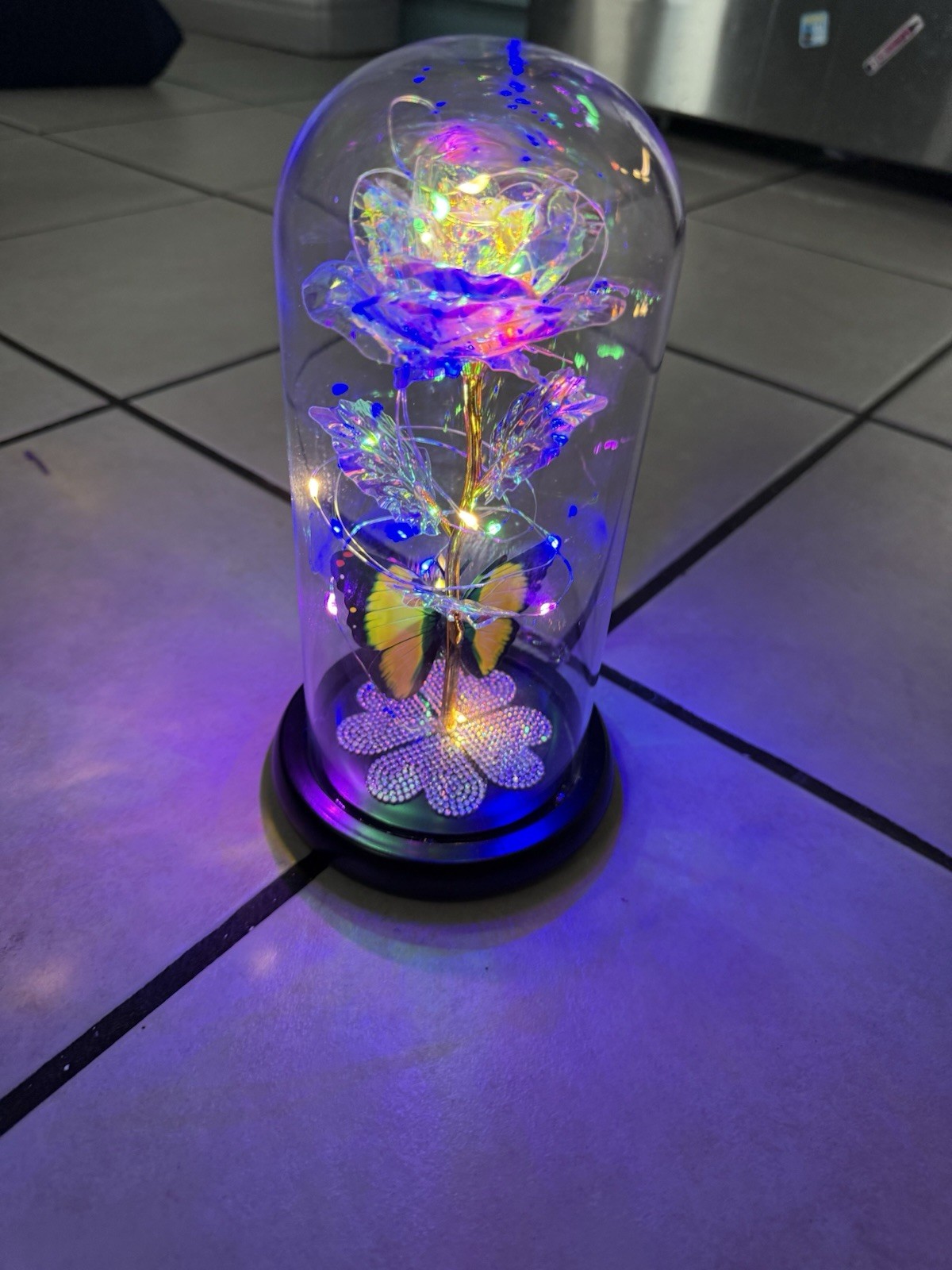 artificial “galaxy” or “eternal” rose in a glass dome with LED lights