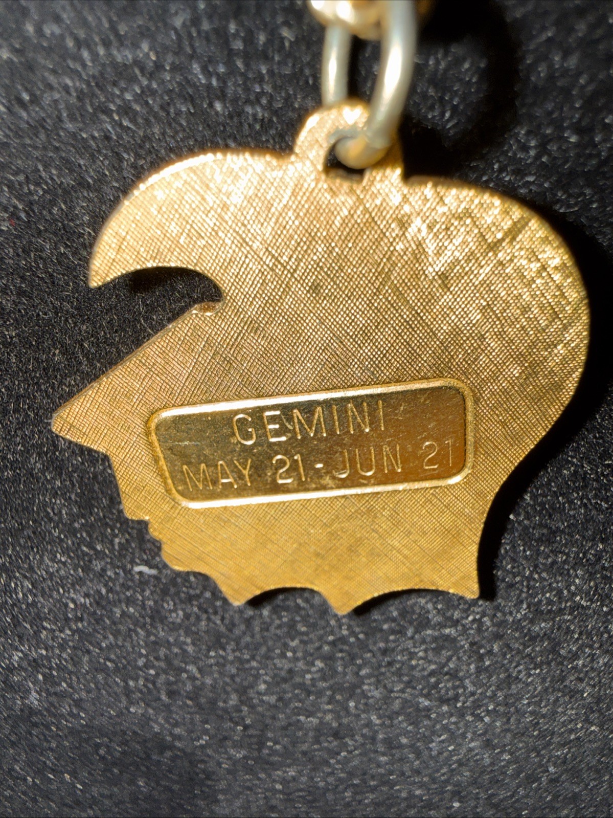Gemini Pendant On Gold Tone Chain.