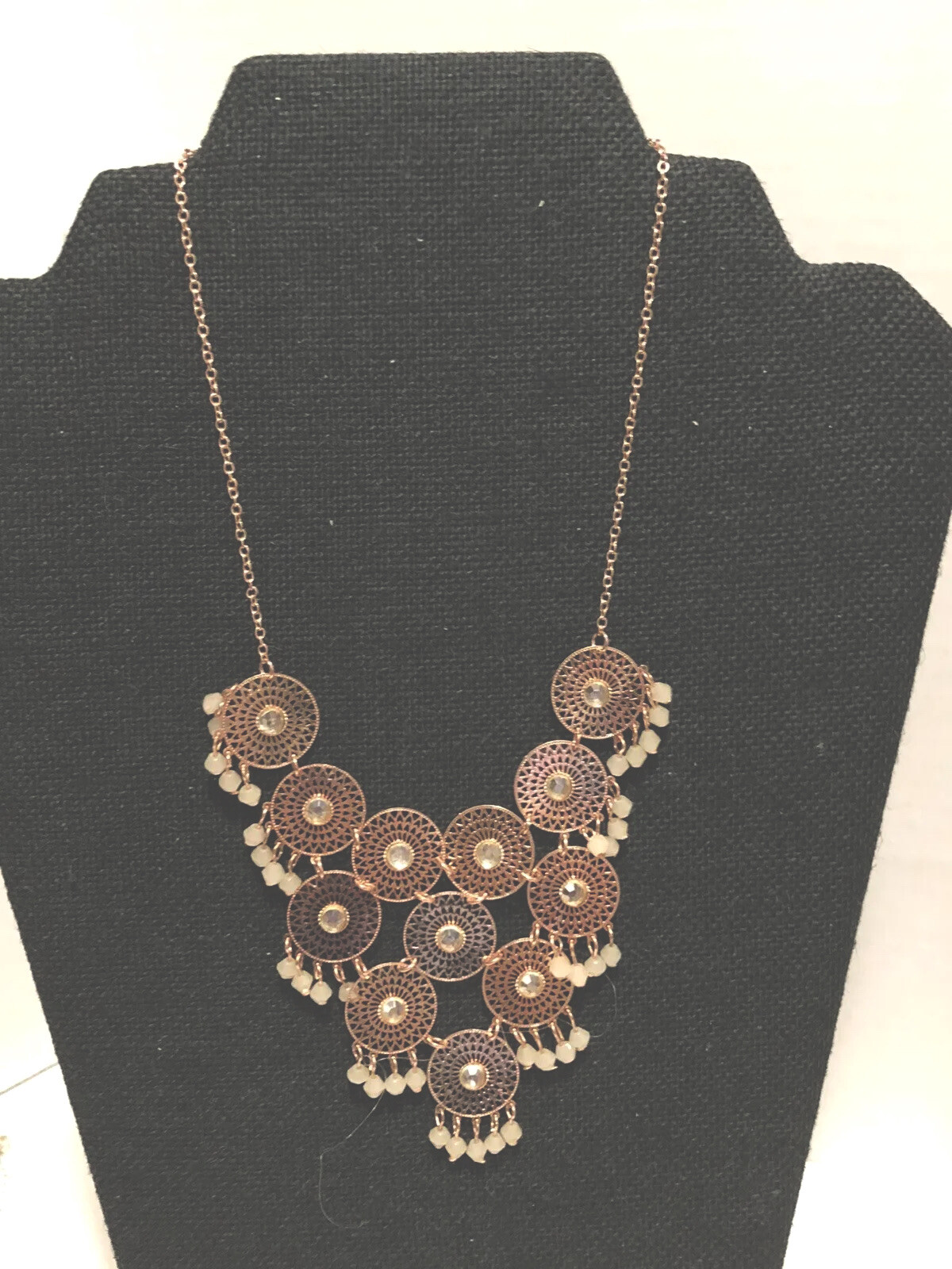 Charming Charlie’s pink rose tone filagree cha cha disc statement necklace