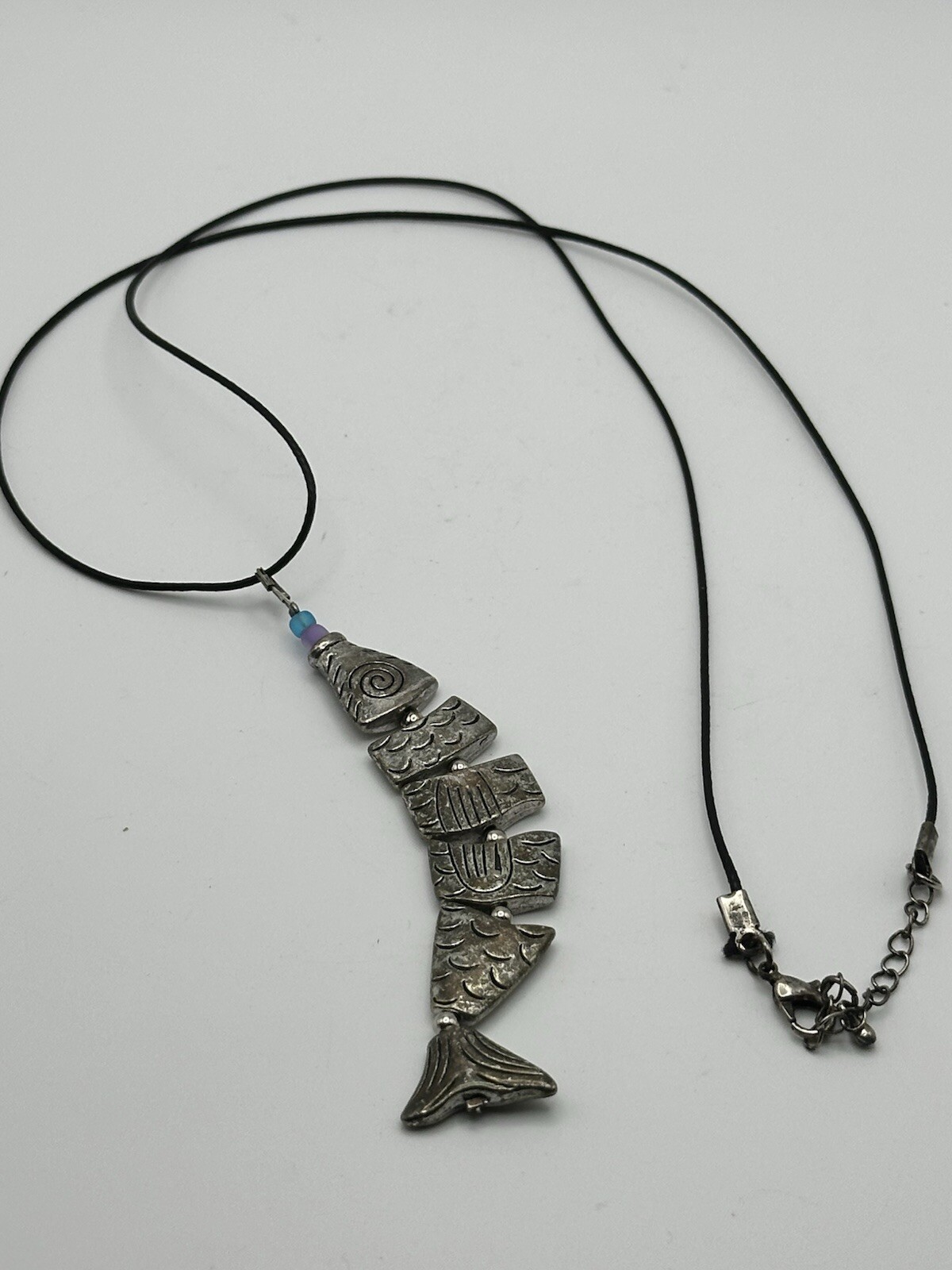 Six Segment Worry Fish Pendant On 24” Nylon Necklace With Lobster Clasp