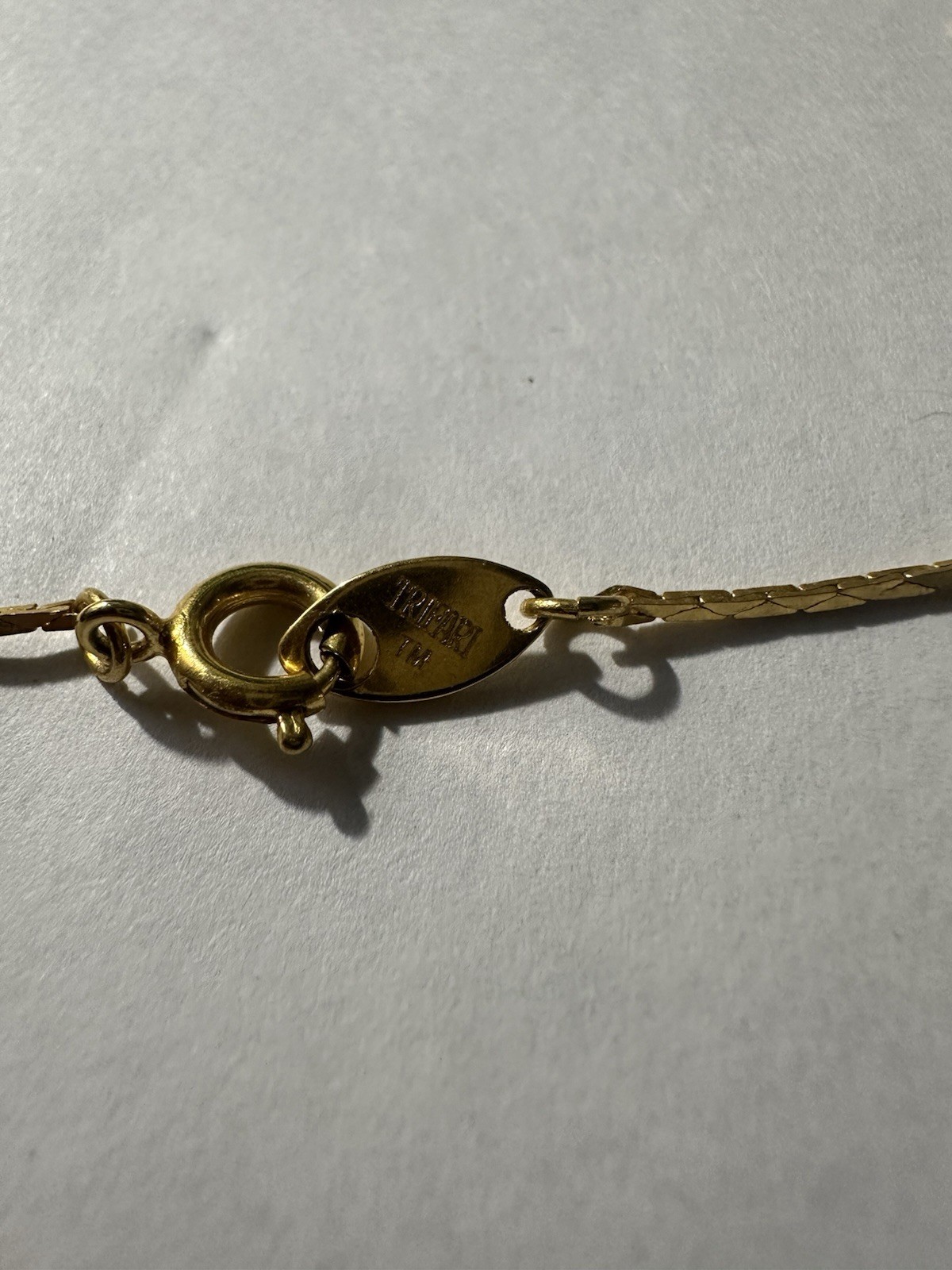 Trifari gold-tone chain features multiple stationed puffy hearts