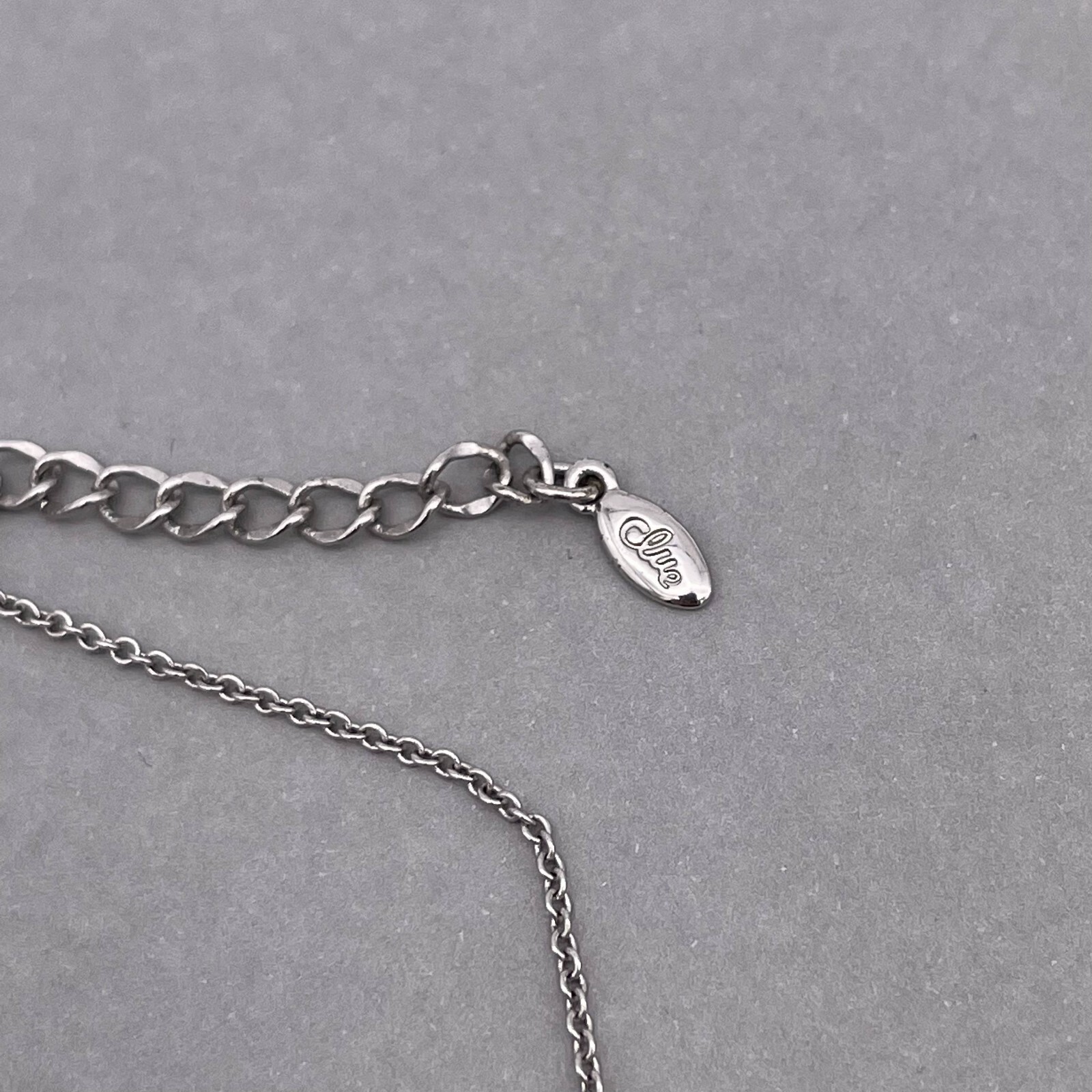 Clue Rhinestone Ball and Bow Link Chain Necklace Silver Tone 15 to 17 in