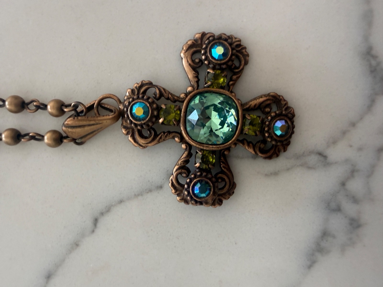 vintage Kirks Folly ornate cross pendant necklace, green crystals, bronze beaded