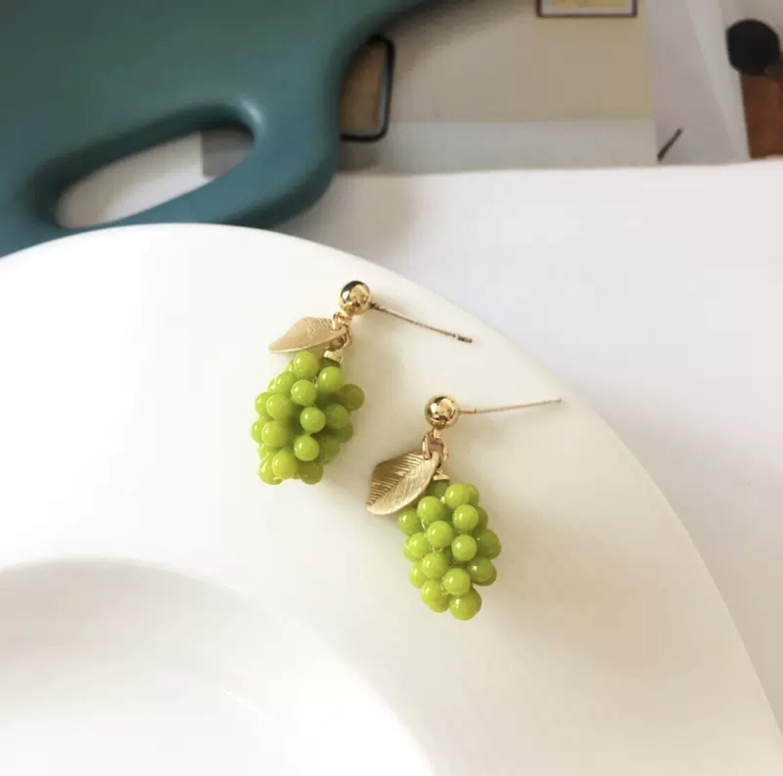 Gold tone cluster grape drop earrings with green glass beads New