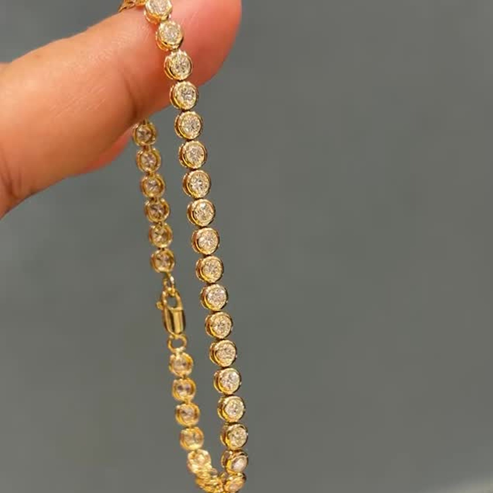 7.0ctw Round Cut Moissanite Bezel Set Tennis Bracelet In 14K Yellow Gold Plated