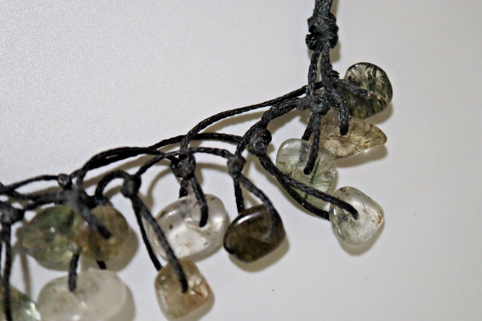 NECKLACE BLACK BRAIDED CORD W/OVER 40 POLISHED RUTILATED QUARTZ STONES 14″-26″