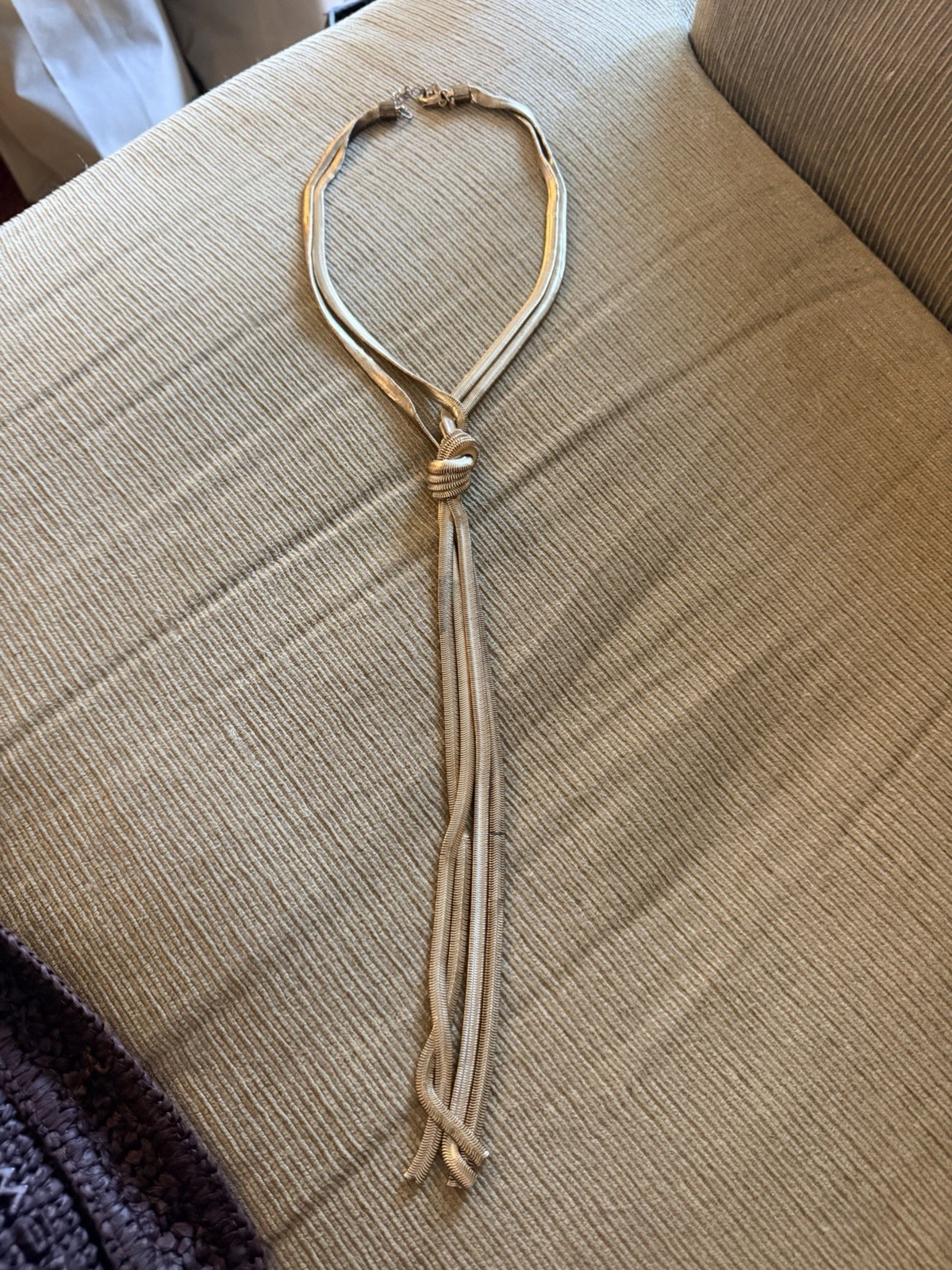 Gold-toned Express lariat necklace snake chain design with a knot