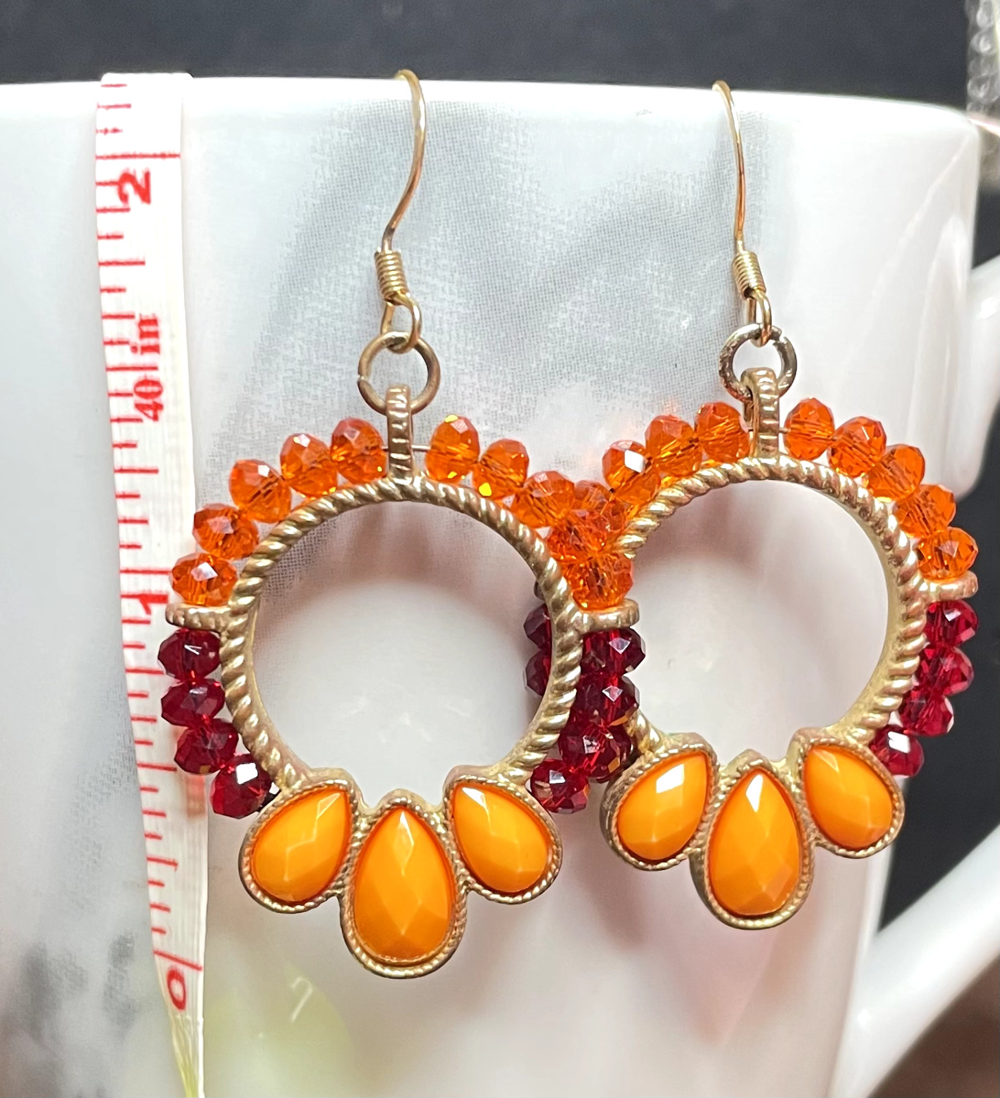 Ladies pre-owned 2.25 inches long dangle earrings orange red gold-tone