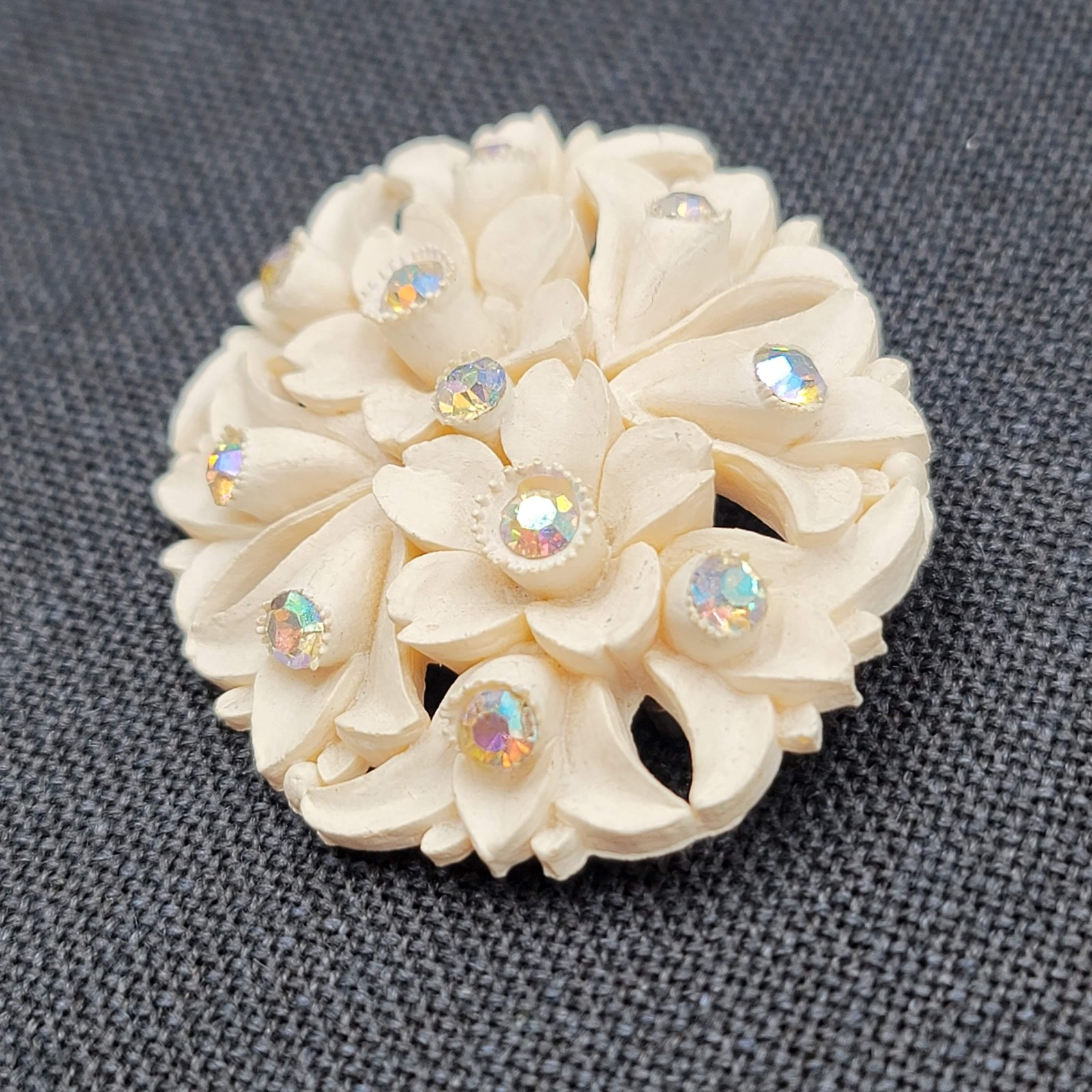 White Molded Flower Brooch Pin Aurora Borealis Rhinestone Oval Early Plastic 2.5