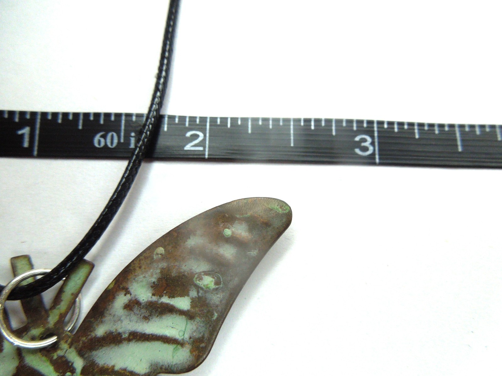 oxidized copper butterfly pendant on black faux leather cord upcycled