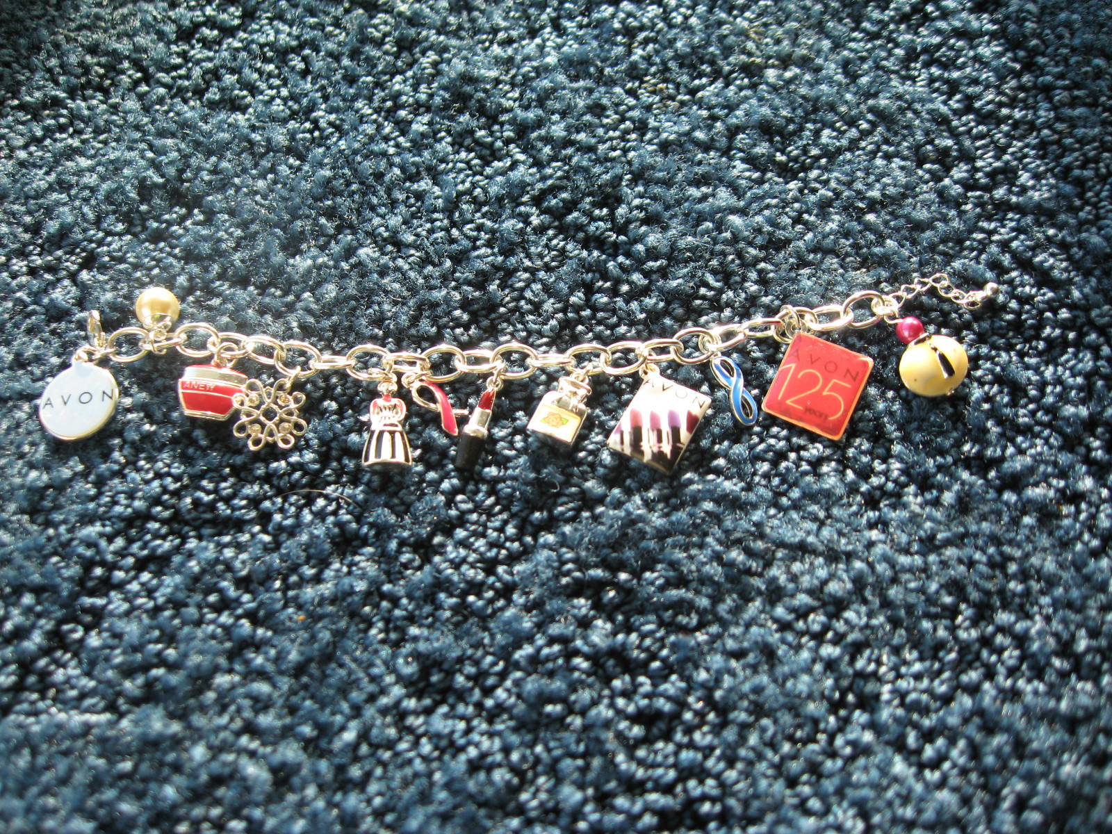 Avon-125th Anniversary-Charm Bracelet-9″ long-12 charms-silver tone metal