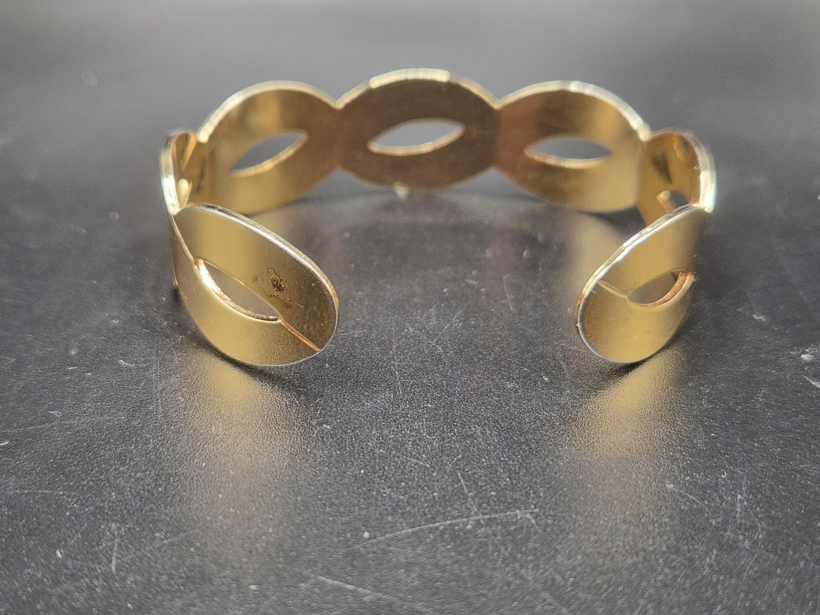 #0313 – Gold Tone Open Cuff Bracelet Satin Finish Ribbon Wave Design 15.1g