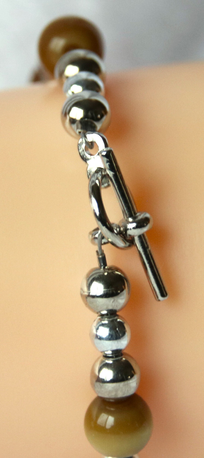 Bracelet of Brown Cat’s Eye Glass with silver colored beads, toggle closure