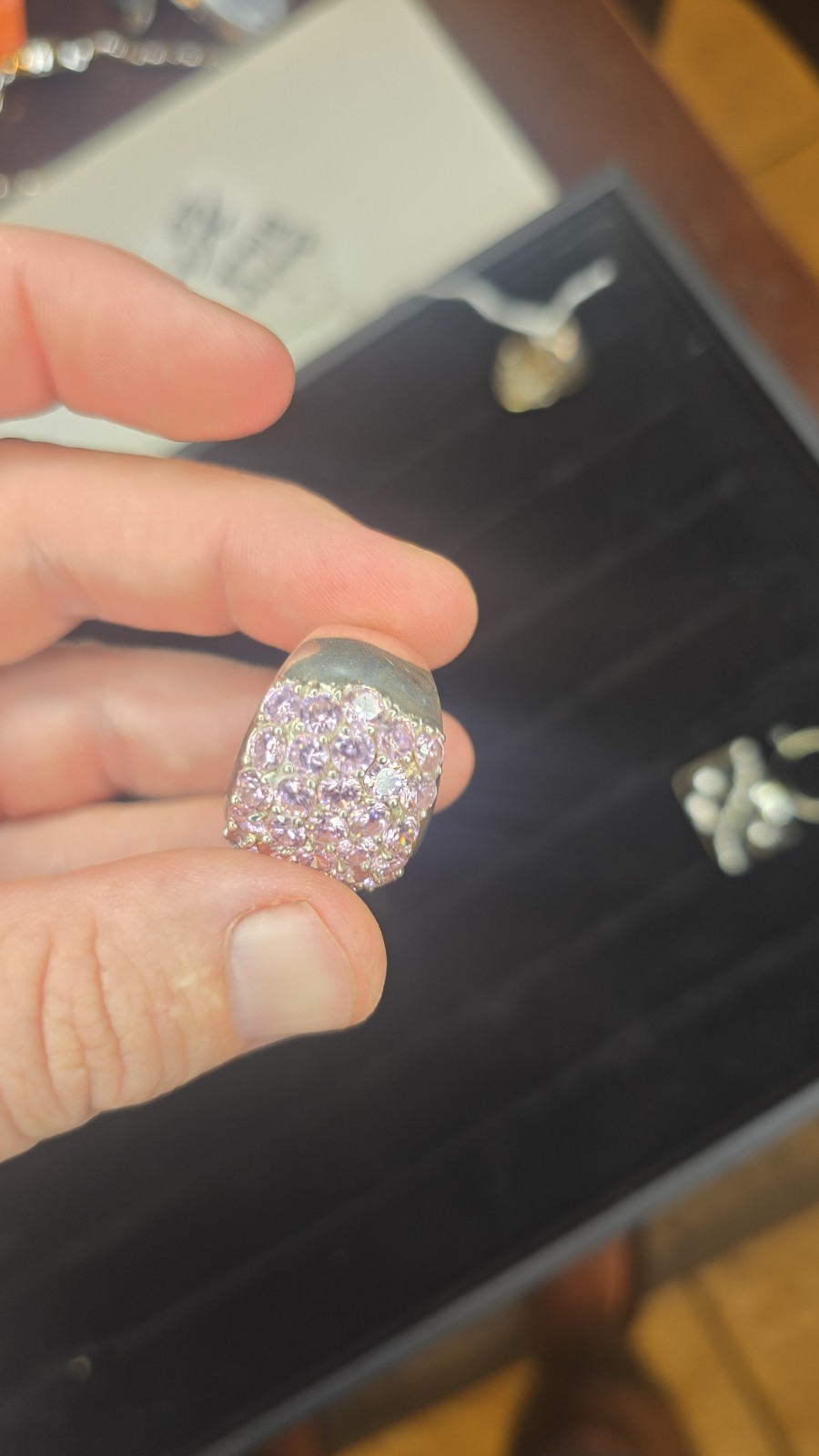 Wide Ring pavé setting of pink gemstones, likely sapphires or cubic zirconia