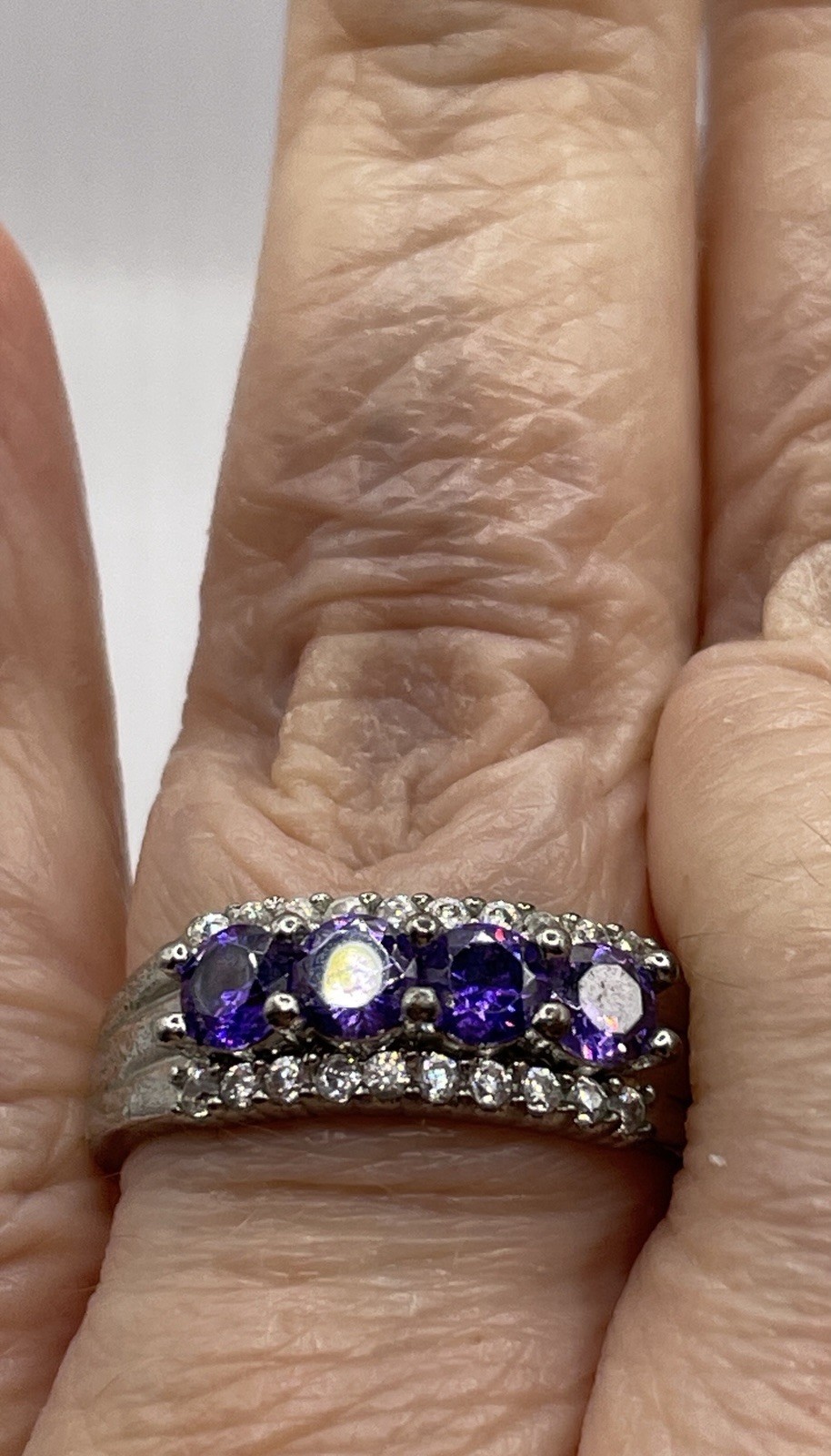 Silver ring with unknown 4 purple stones 10 tiny clear chip stones size 9