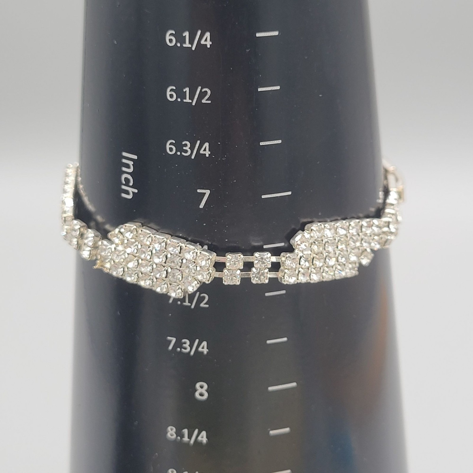 Silver Tone Bracelet With Cascading Multi Row Rhinestones Fold Over Clasp
