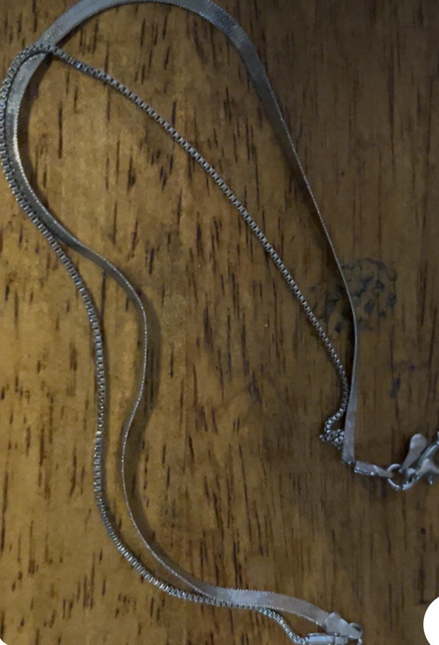 layered silver-tone necklace featuring a flat herringbone chain paired