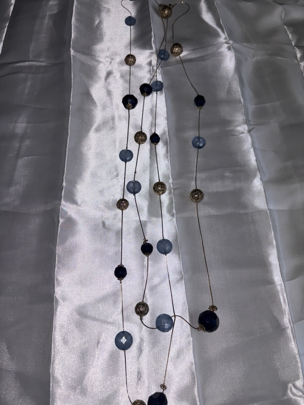 Premier Designs necklace features blue acrylic beads and gold spheres