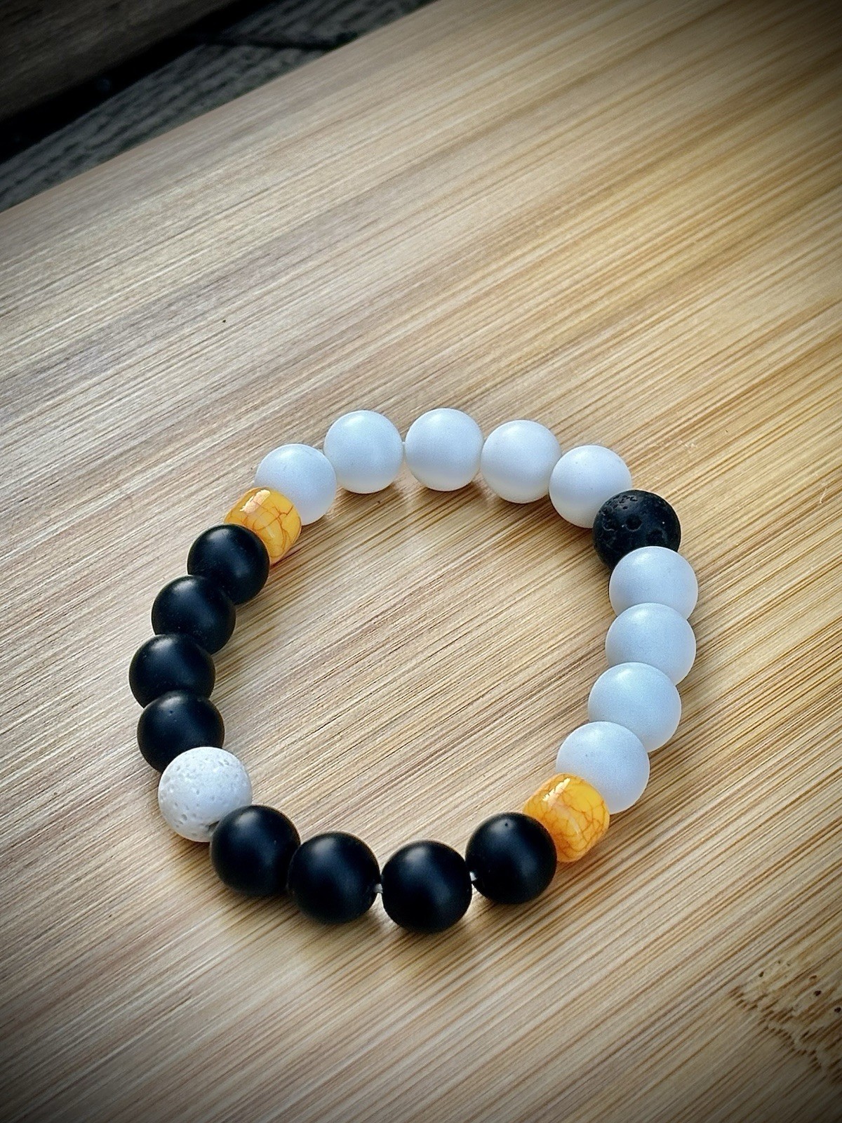 Bracelet with matte black/ white onyx, lava stone and yellow bohemian.