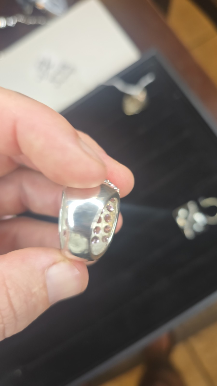 Wide Ring pavé setting of pink gemstones, likely sapphires or cubic zirconia