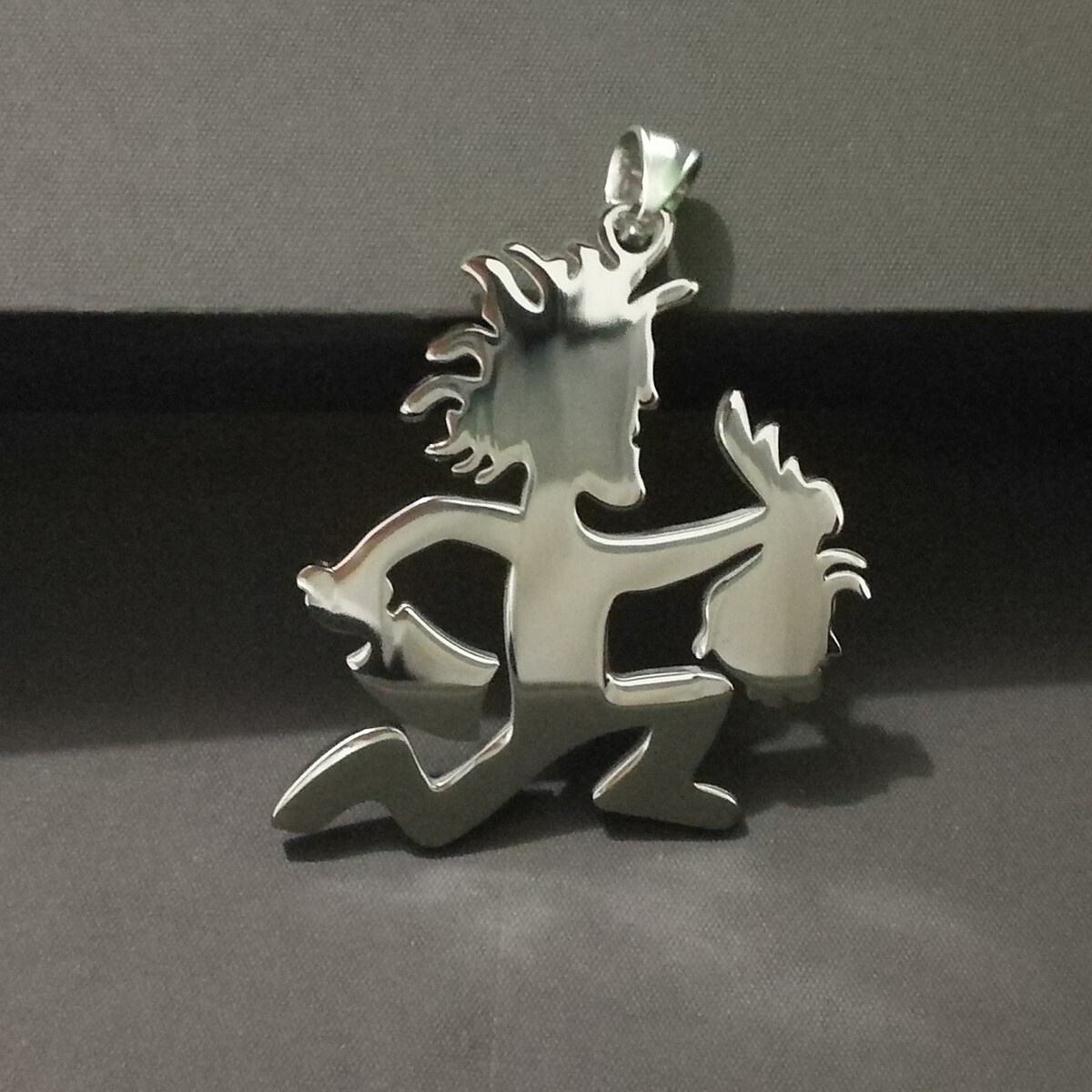 ICP Juggalo holding a severed Juggalette Head pendant w/30 inch ball chain