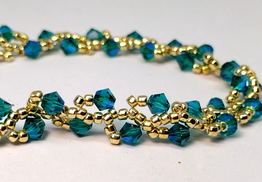 Bracelet 8-inch – 4mm Aurora Borealis Color Crystal Bicone Beads w/ Gold Beads.