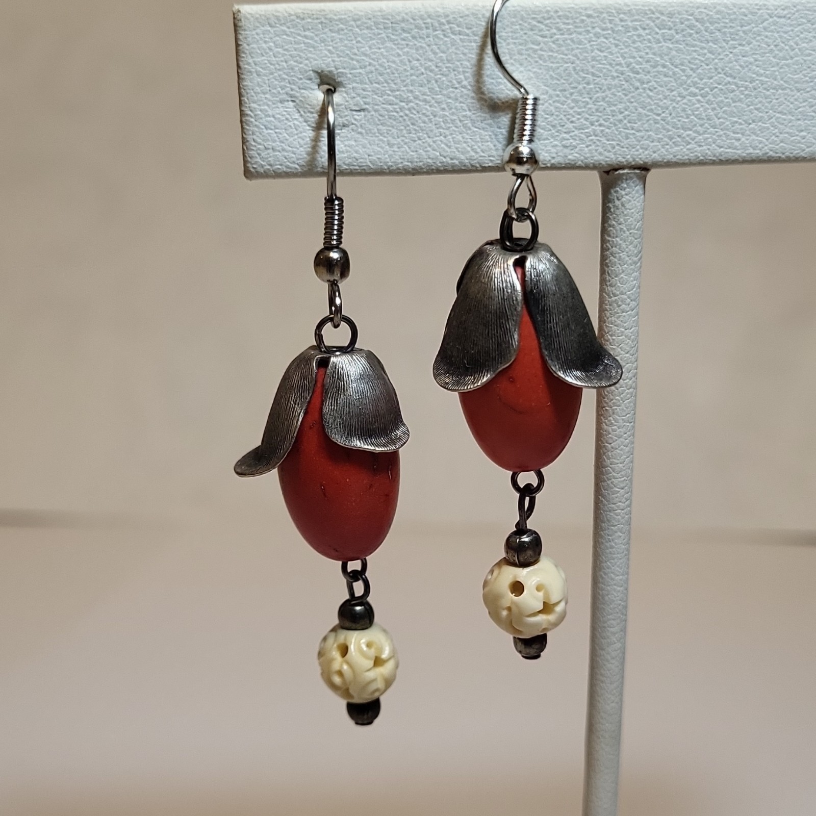 Handcrafted dangle earring featuring a large red coral Seed & Ivory Bead.