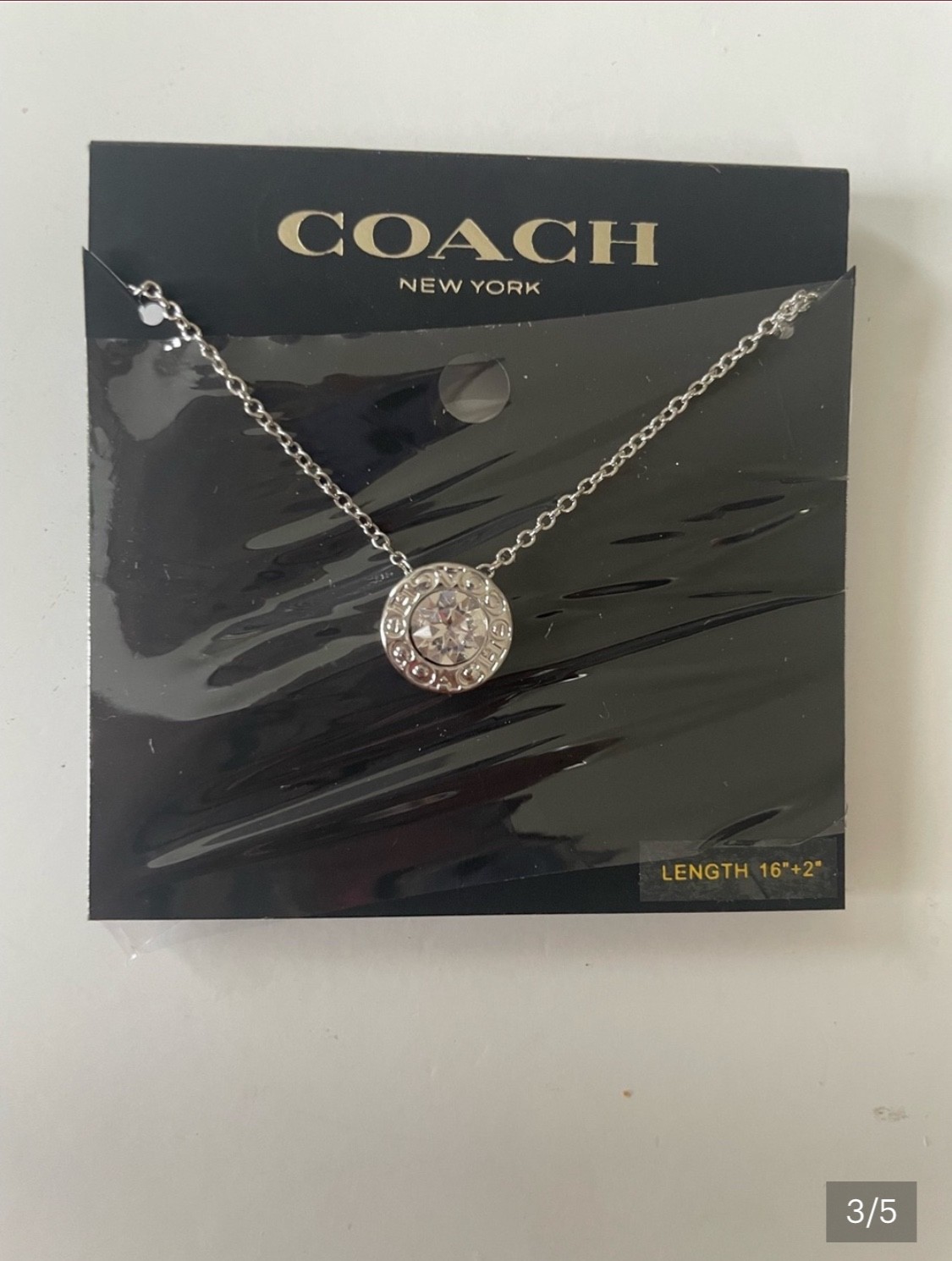 Silver , still in the packaging Coach necklace