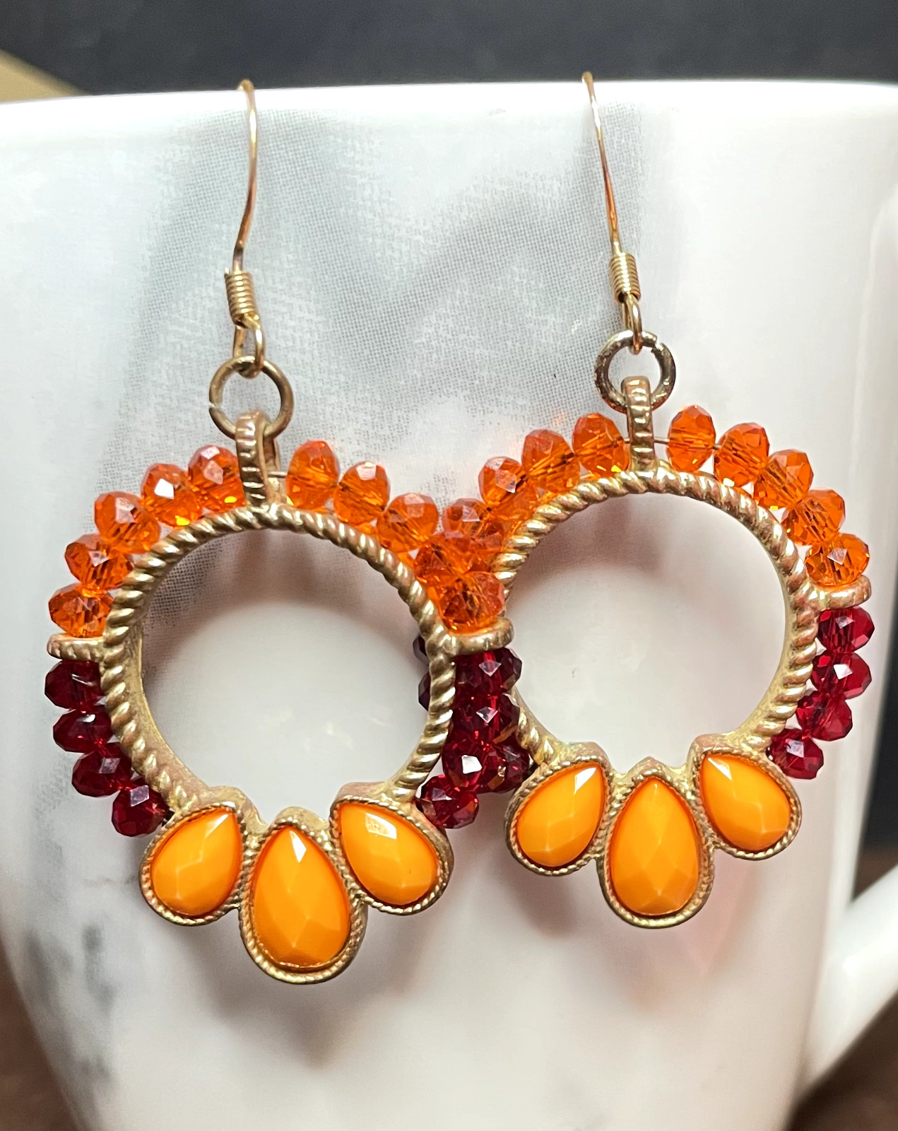 Ladies pre-owned 2.25 inches long dangle earrings orange red gold-tone