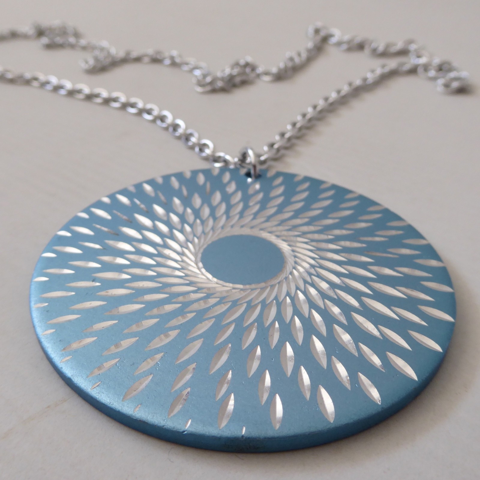 Conrah cristillium pendant necklace. Aluminium anodised blue metal. Geometric