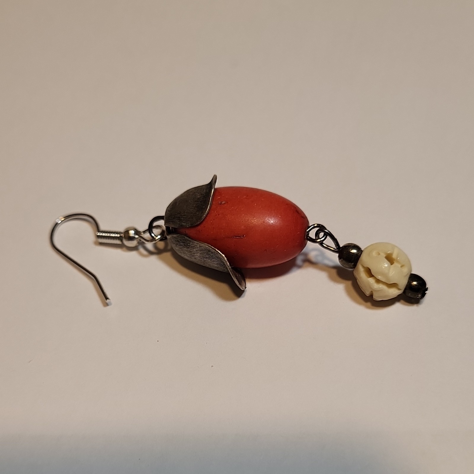 Handcrafted dangle earring featuring a large red coral Seed & Ivory Bead.