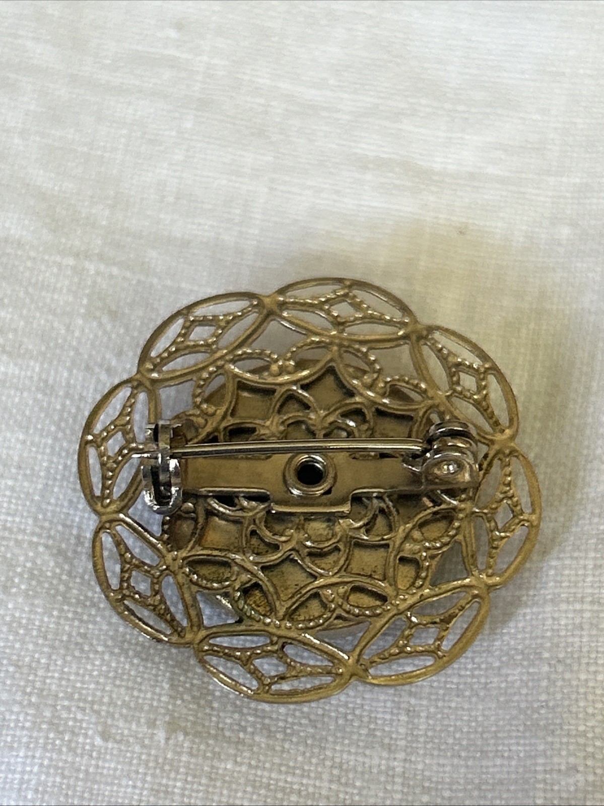 Petite Brooch Rhinestone Pin On Delicate Gold Tone Pressed Tin Filagree