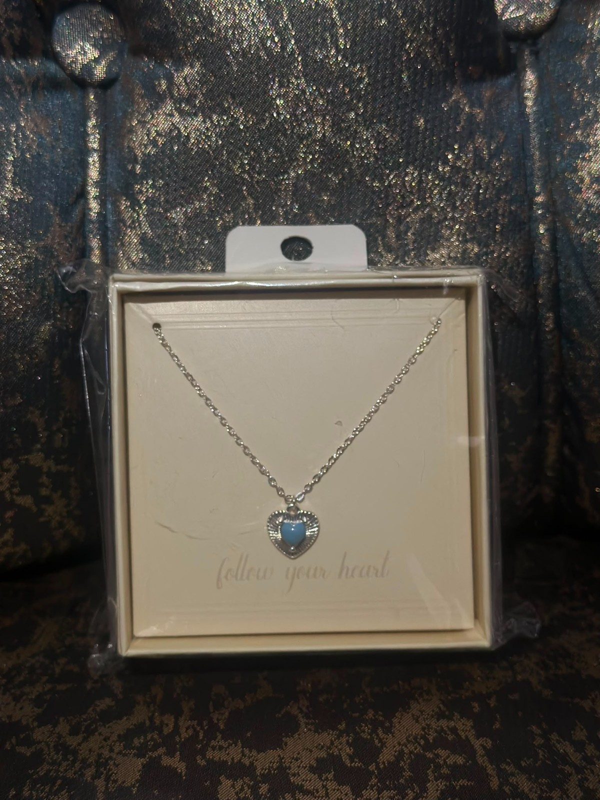 A smooth, rust-resistant silver chain featuring an elegant and attractive blue h