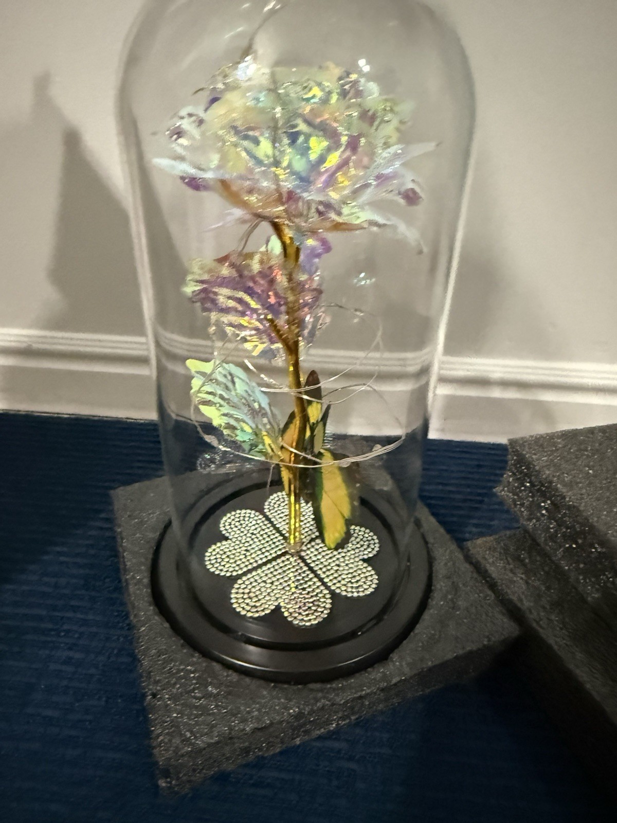 artificial “galaxy” or “eternal” rose in a glass dome with LED lights