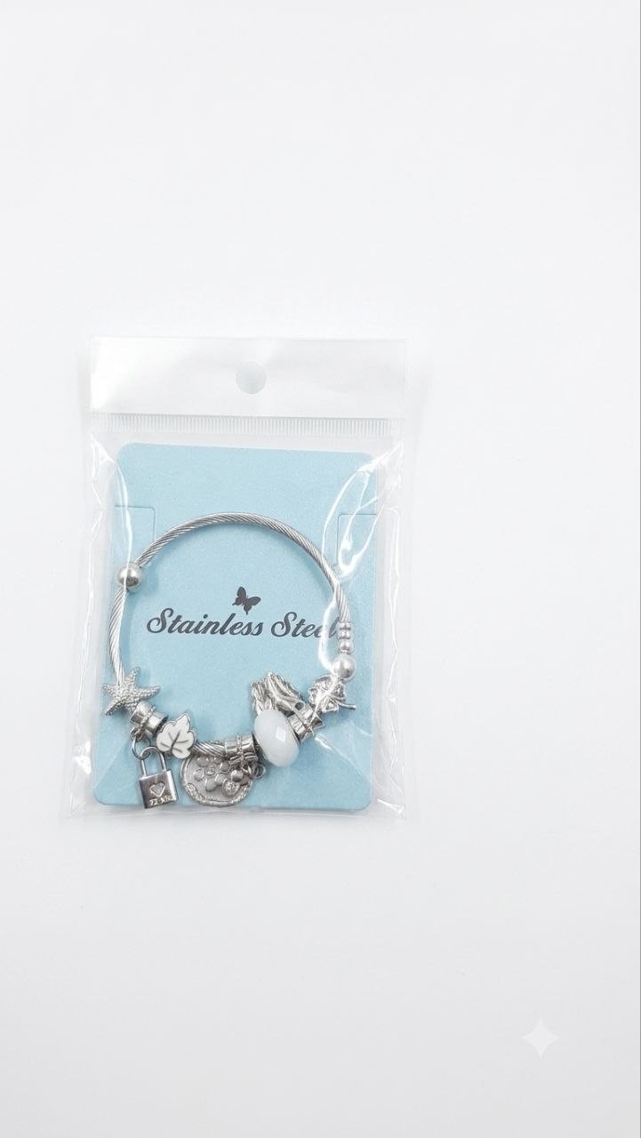 Beautiful silver-tone charm bangle bracelet featuring unique pendants and a gem