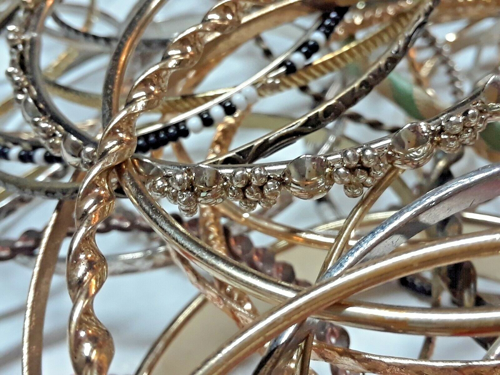 Bangle bracelets. gold tone silver tone, metal, plastic, with patterns. Lot