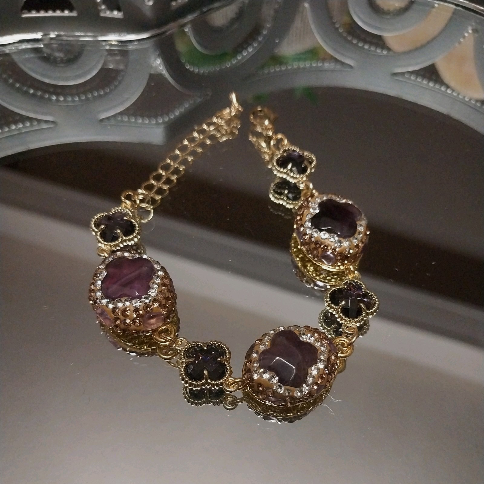 Gold Plated bracelet with purple amethysts and sparkling clover-shaped crystals.