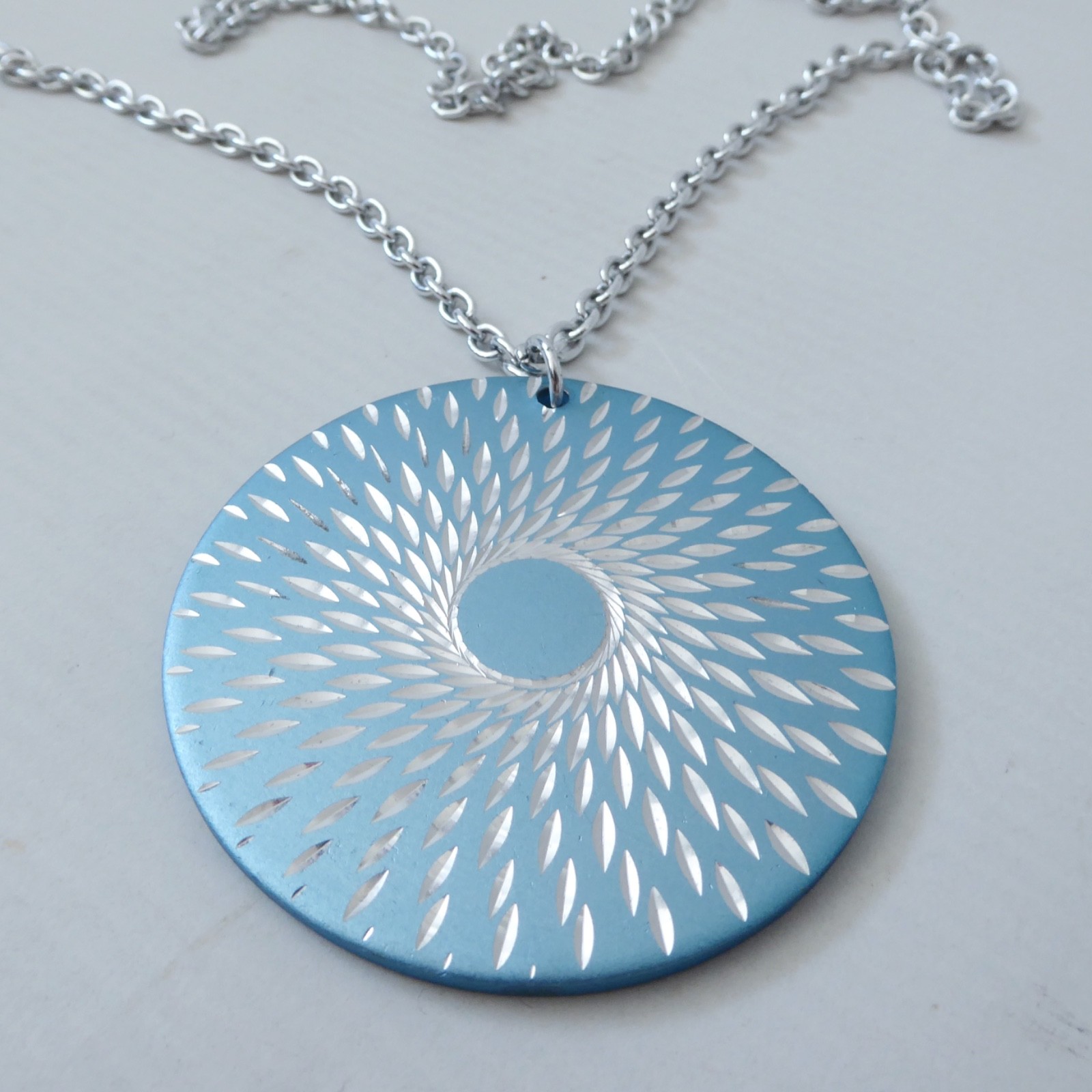 Conrah cristillium pendant necklace. Aluminium anodised blue metal. Geometric