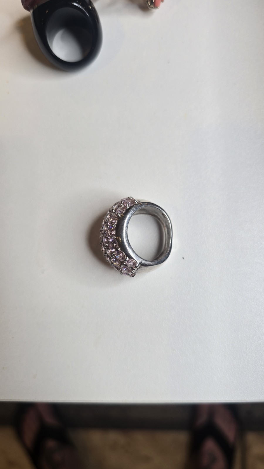 Wide Ring pavé setting of pink gemstones, likely sapphires or cubic zirconia