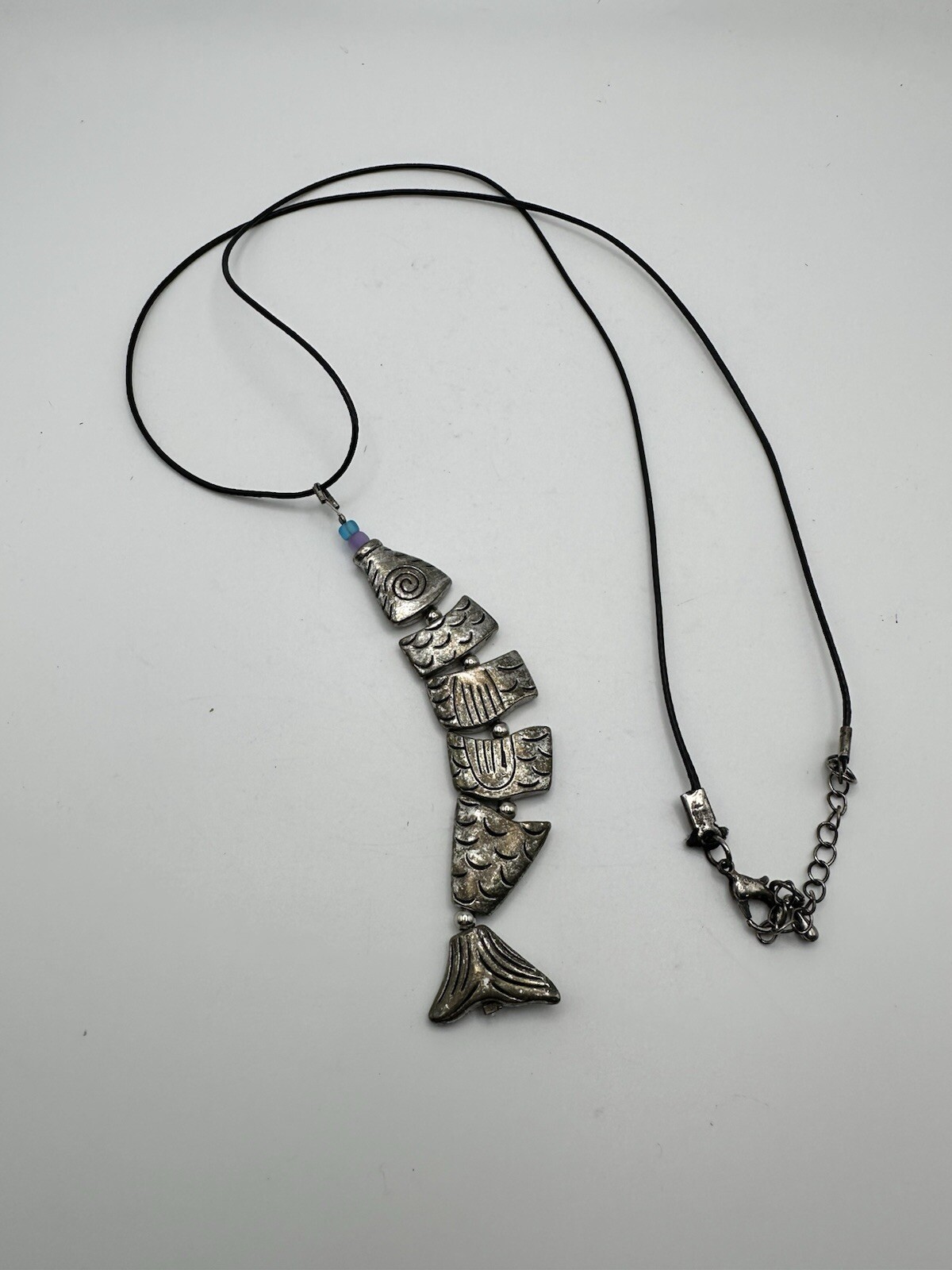 Six Segment Worry Fish Pendant On 24” Nylon Necklace With Lobster Clasp