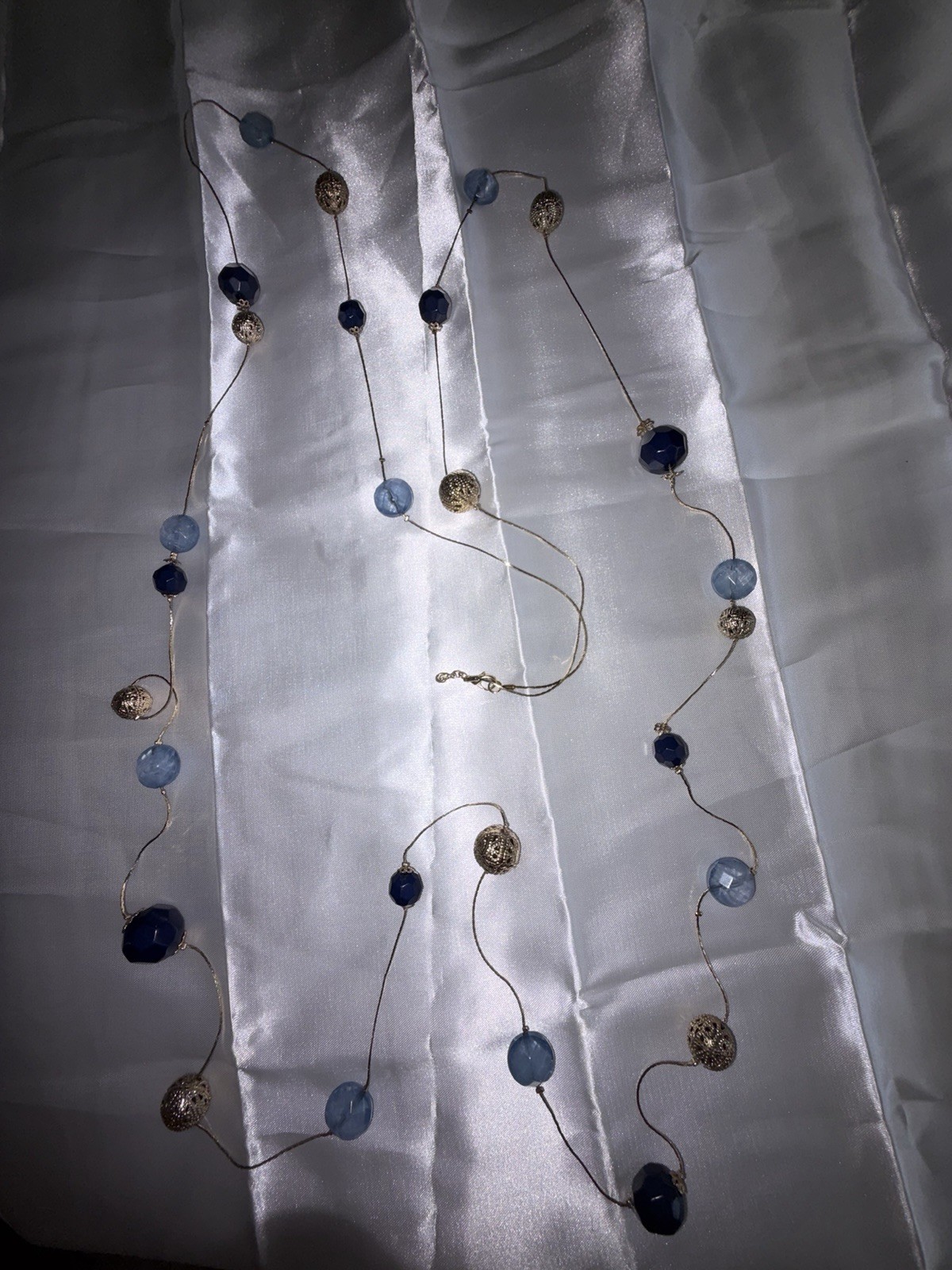 Premier Designs necklace features blue acrylic beads and gold spheres