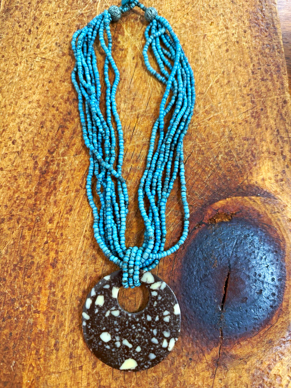 Multi-Strand Blue Glass Beaded Necklace with Brown Speckled Round Charm