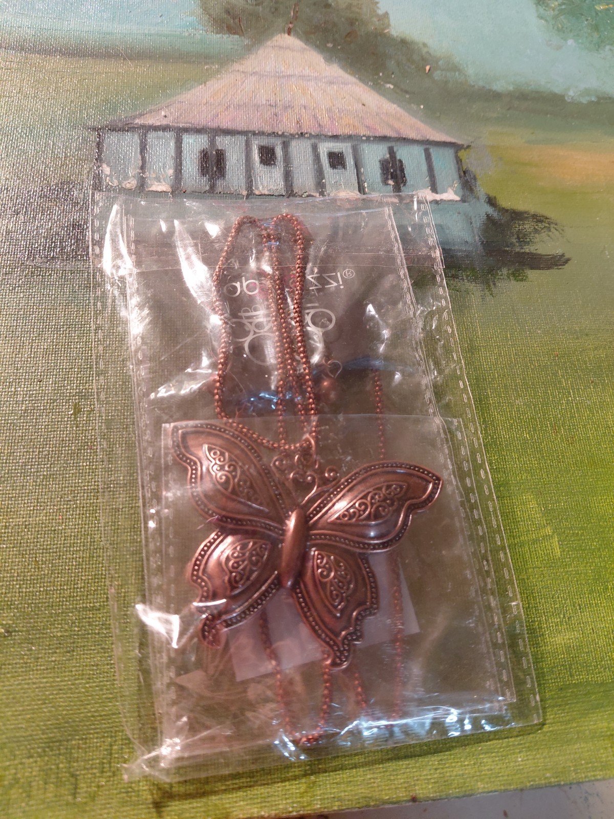 Paparazzi copper butterfly necklace with an adjustable clasp closure